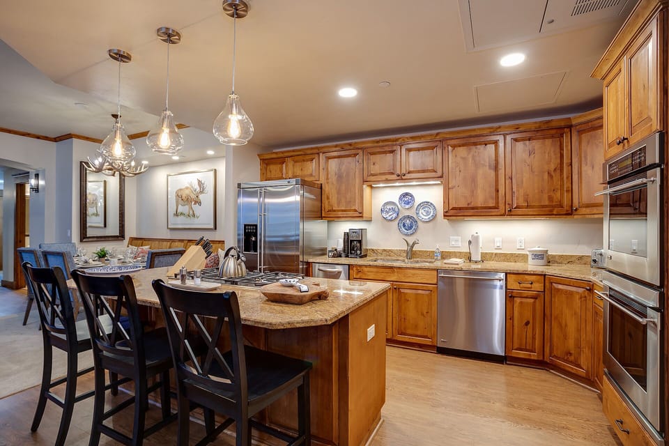 Your fully-equipped gourmet kitchen awaits with granite counters, stainless appliances, and an inviting island perfect for cooking and gathering together.