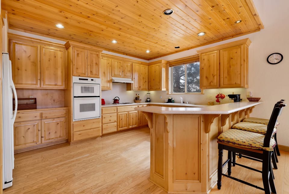 Fully equipped cabin kitchen with ample cabinetry, stove, fridge, microwave, and coffee maker—perfect for cooking meals, morning coffee, and feeling right at home on your stay.