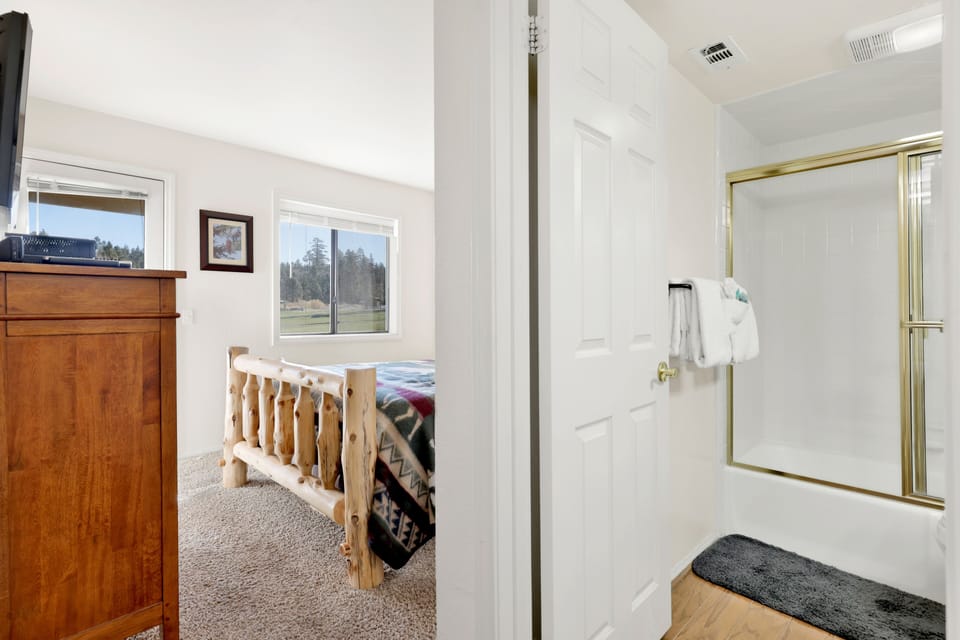 Hallway connecting the bedroom and bathroom, offering easy access and a comfortable flow throughout the sleeping area.