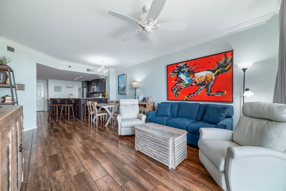 A comfortable living room with ample seating, flowing into a dining area, ideal for everyday living and gatherings.