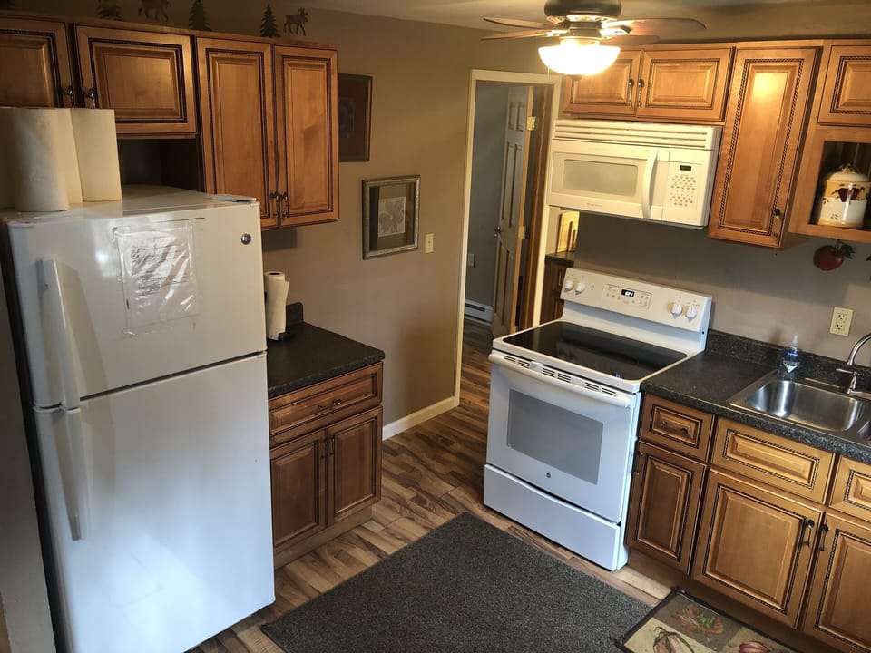 Kitchen. The open door is the entrance to master bedroom. 