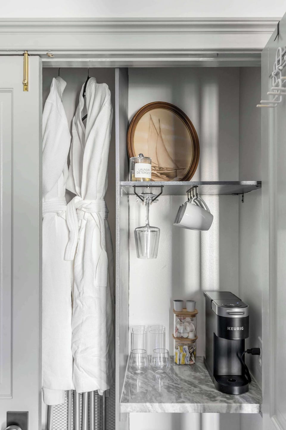 Start your day with ease at this convenient coffee bar, complete with a Keurig machine, an assortment of pods, glassware, and mugs. 