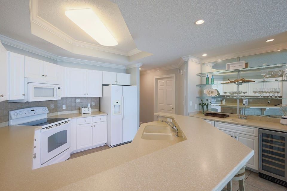 Sip your morning coffee at the breakfast bar and get ready for a beach day in this stylish space