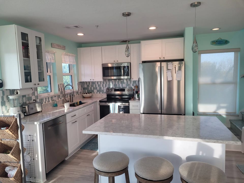 Sit at the island as meals are prepared in our newly remodeled kitchen.