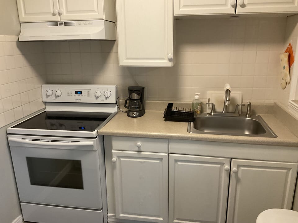 Complete kitchen with apartment size refrigerator, blender and microwave