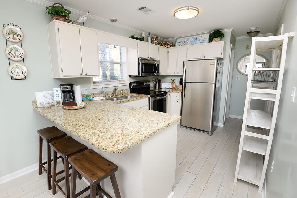 Kitchen with additional counter seating and lots of food pantry storage