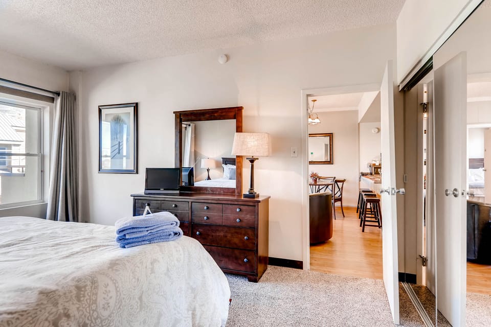 One bedroom has a king-size bed and large windows.