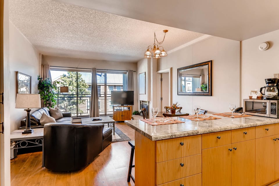 Comfortable open concept kitchen, dining, and living room.