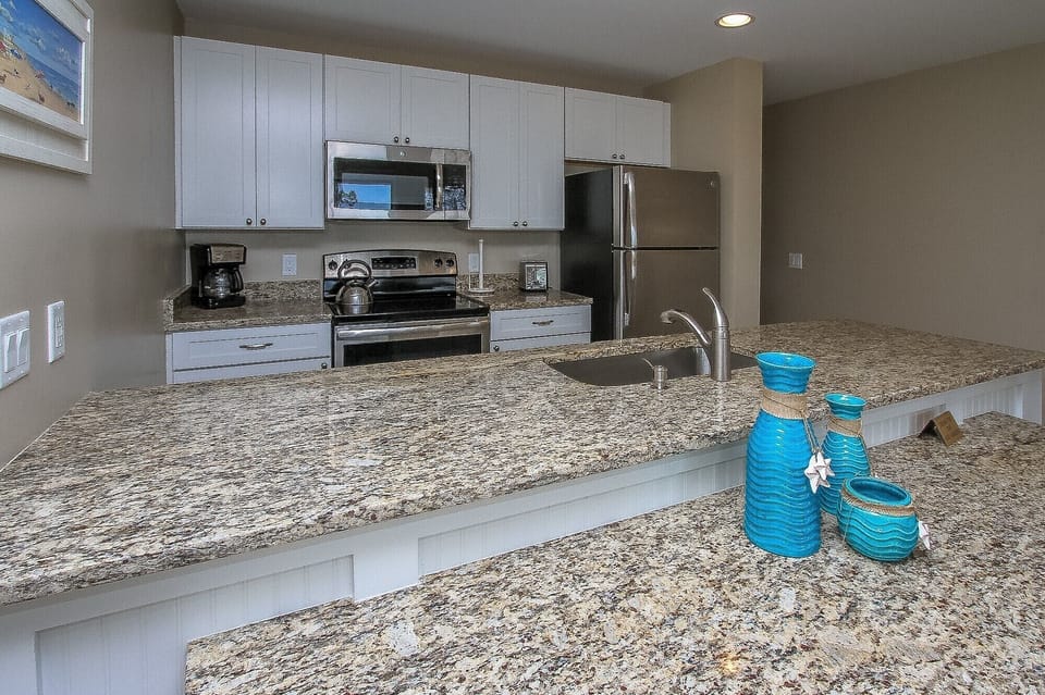 Ocean Dunes 316 - Fully Equipped Kitchen - The newly renovated Kitchen / Dining Area features all stainless appliances, granite counters and dining bar having seating for four, and tile flooring throughout.