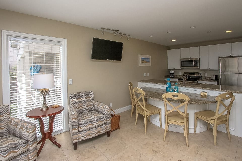 Ocean Dunes 316 - View into Villa from Balcony - The newly renovated Kitchen / Dining Area features all stainless appliances, granite counters and dining bar having seating for four, and tile flooring throughout.