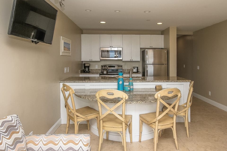 Ocean Dunes 316 - Dining Area with seating for Four - Completely furnished kitchen that looks to dining area and ocean view