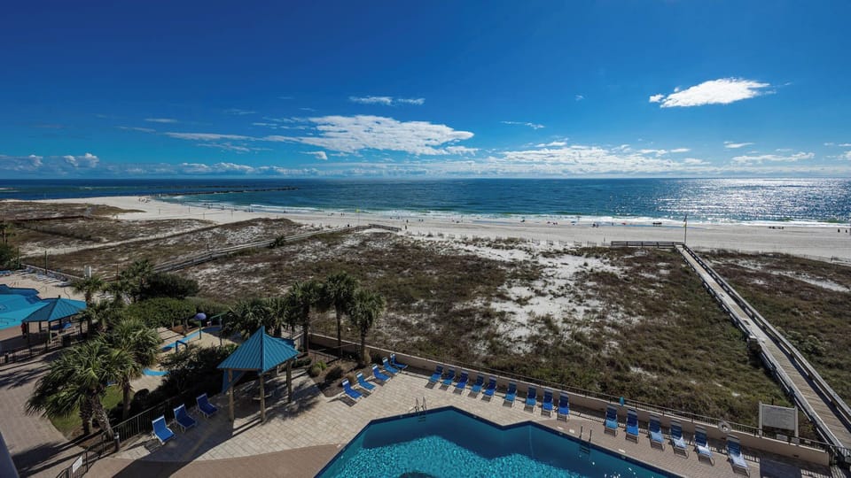 Take in the stunning views from the balcony, where you can relax by the pool and enjoy the coastal atmosphere