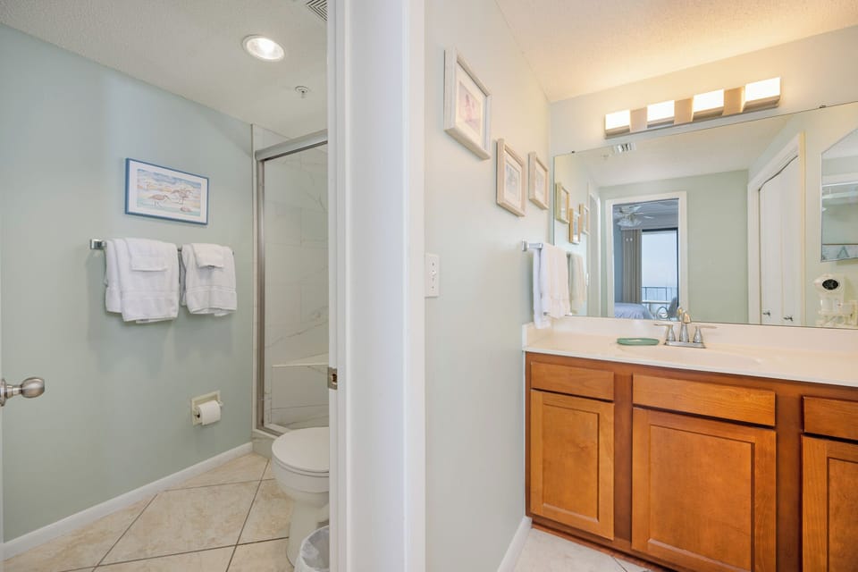A gleaming vanity with soft lighting invites you to prepare for the day in the master bath