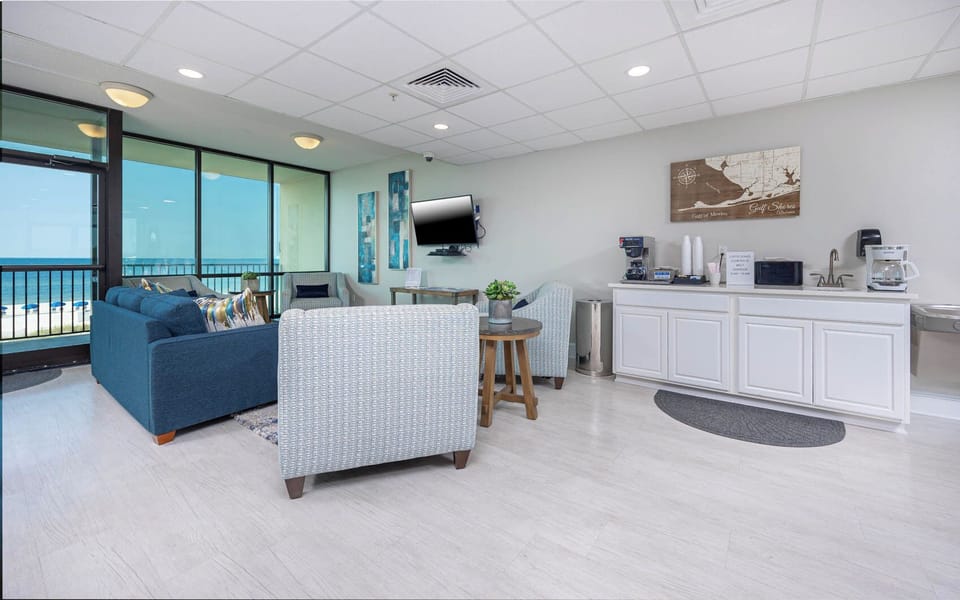 Relax in this inviting lounge with a beachfront view and coffee, perfect for unwinding and planning your next adventure