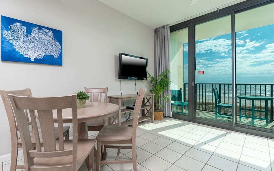 Dine at the round table or relax on the sofa while enjoying beachfront views from the balcony
