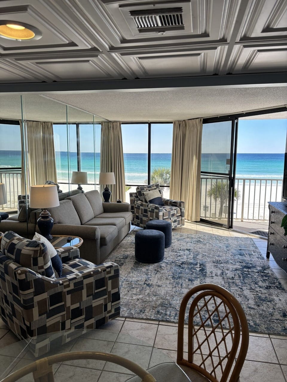 Living room with patio door onto balcony with unobstructed beach views