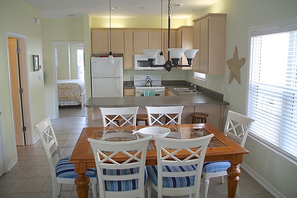 First floor offers a bedroom with a queen-size bed and full bath with tub shower