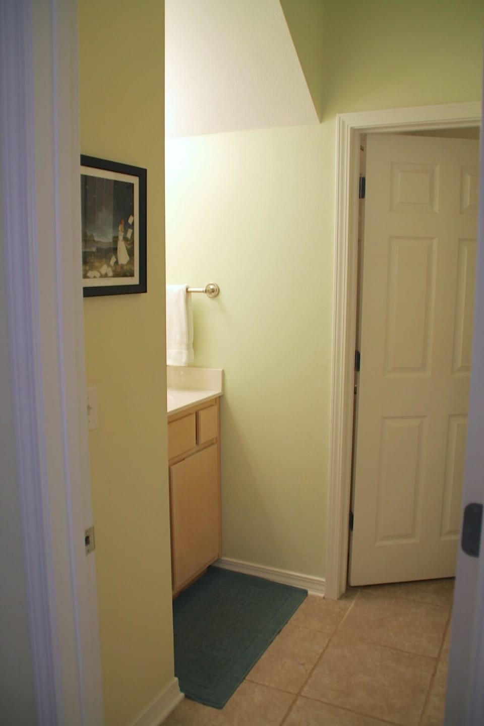 The downstairs bathroom is off the kitchen area and has a full tub shower