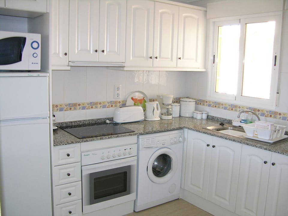 The kitchen is fully equipped with oven, hob, microwave and washing machine.