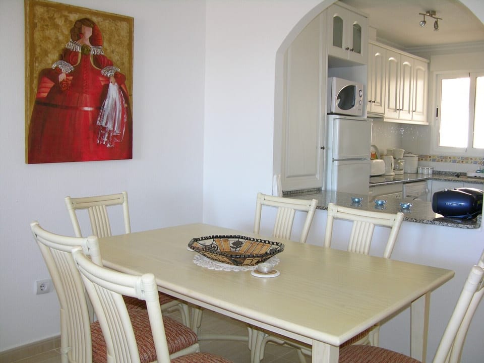 Luxurious apartment with specious dining room including modern furniture, dishes, bottles and more.