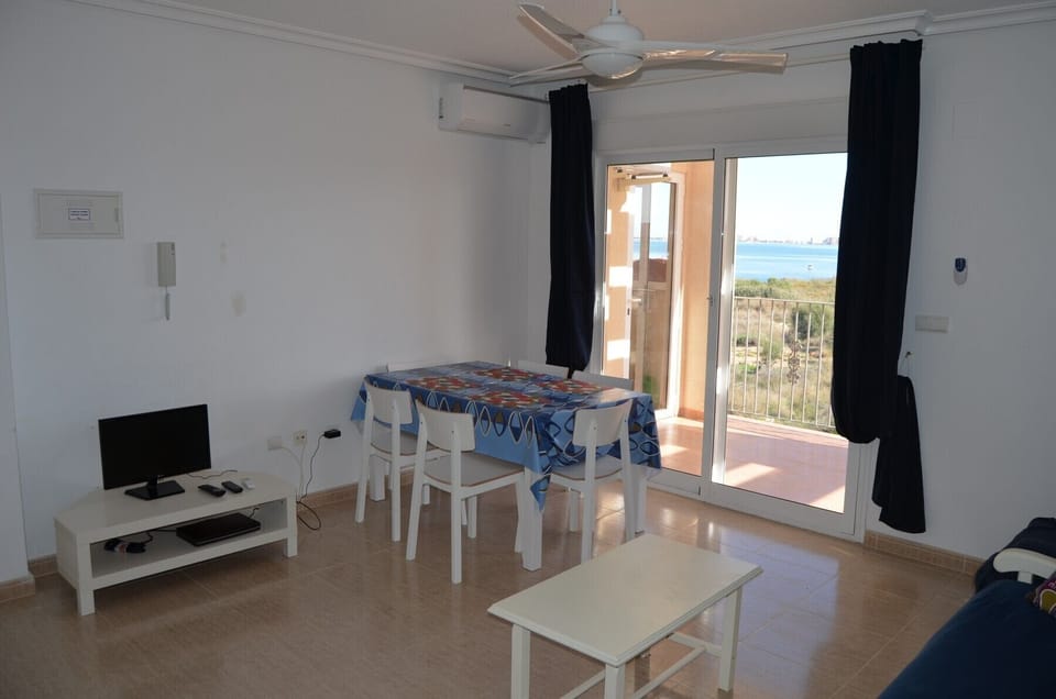 Spacious dining room having comfortable dining furniture near living room