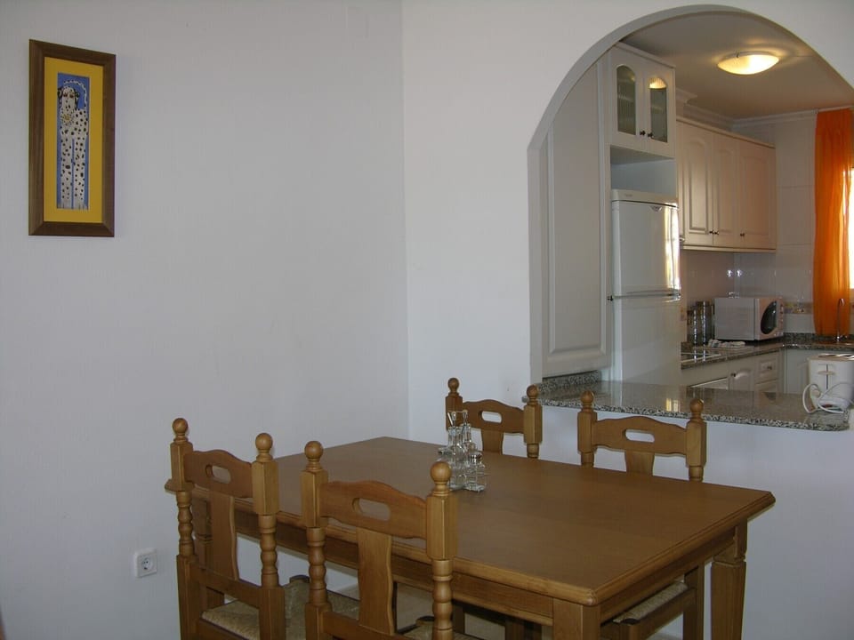 Luxurious apartment with specious dining room including modern furniture, dishes, bottles and more.