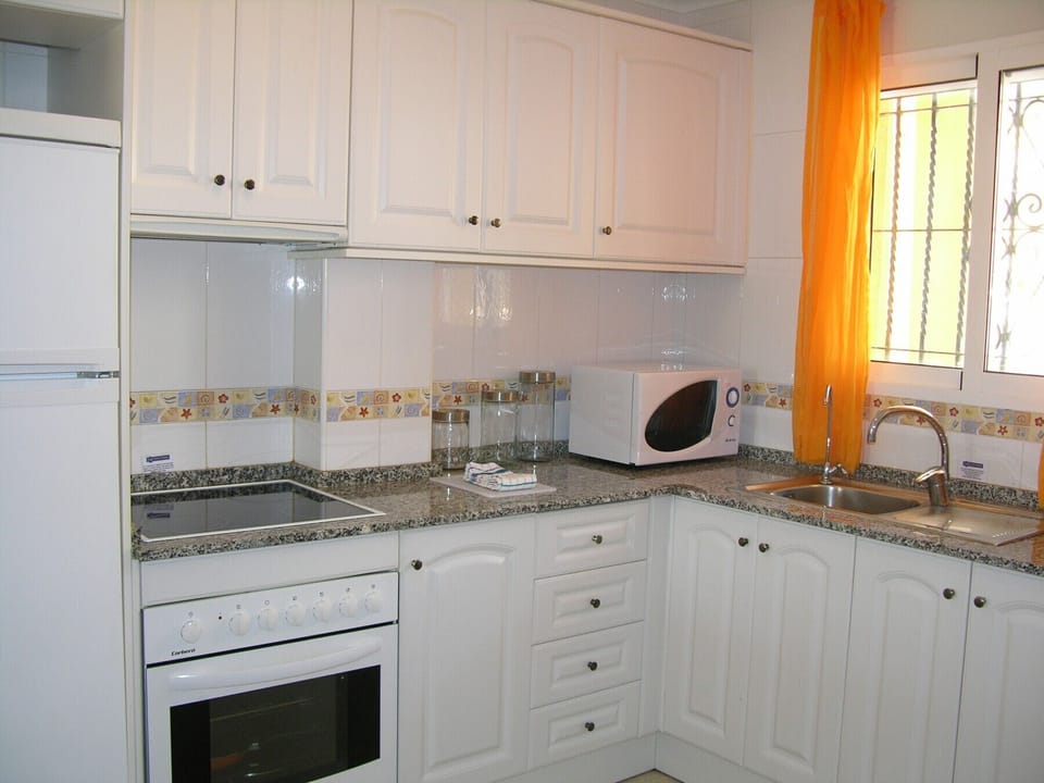 The kitchen is fully equipped with oven, hob, microwave and washing machine.