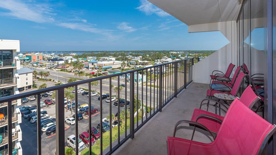 Enjoy a relaxing view from the balcony with seating, overlooking vibrant coastal scenery and nearby attractions