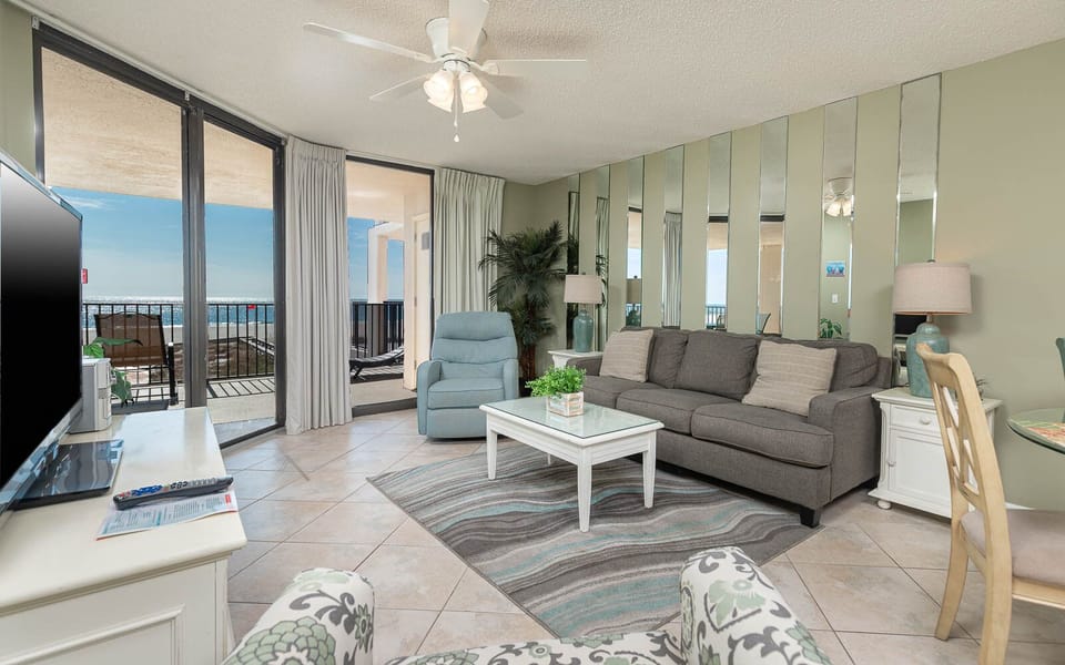 Relax in the inviting living area featuring a queen sleeper sofa, stylish decor, and beach balcony access