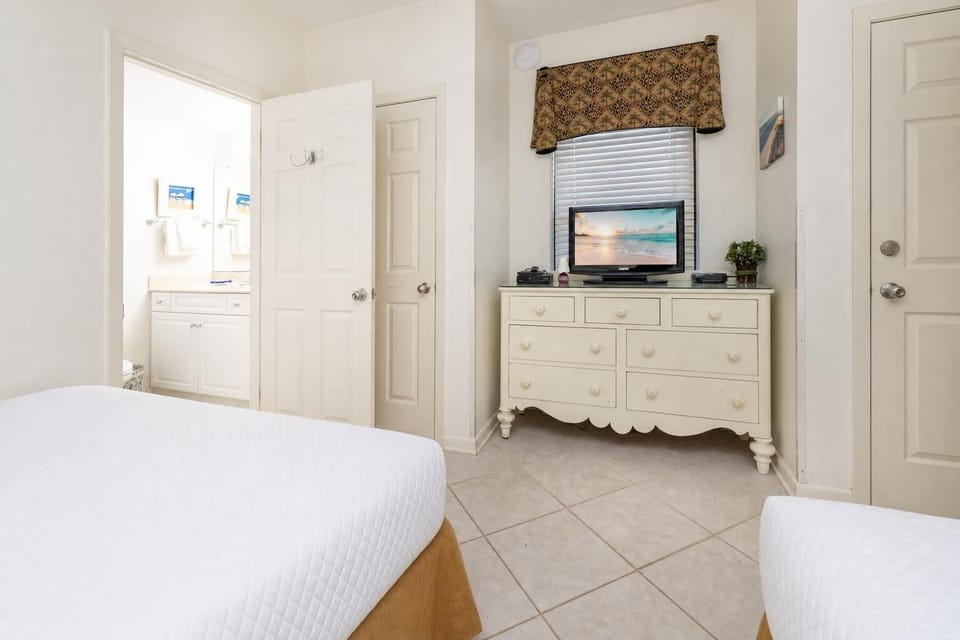Relax in this guest room featuring cozy queen beds, a TV for entertainment, and an en-suite bathroom