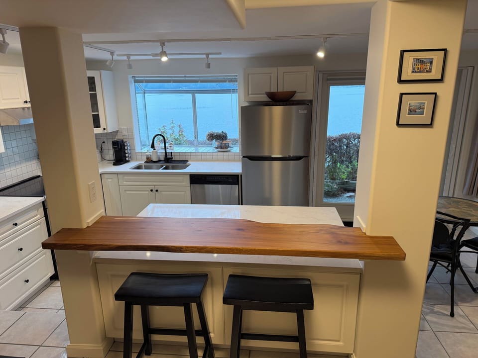 New live edge bar table looking through kitchen to the ocean