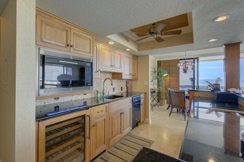 Fully stocked kitchenette with wine refrigerator and solid stone counters.  There is a small refrigerator/freezer only, two burner stove top without a