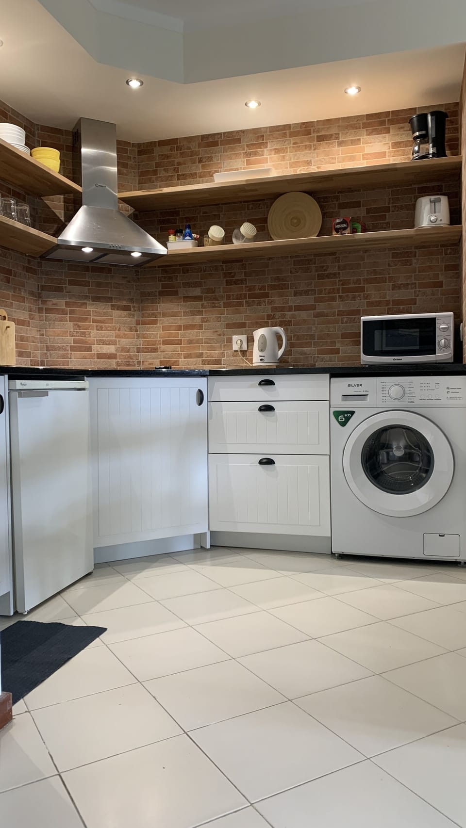 Kitchenette with microwave, washing machine, refrigerator 