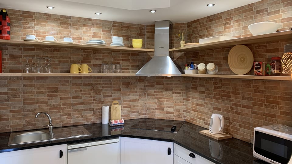Kitchenette with microwave, washing machine, refrigerator 