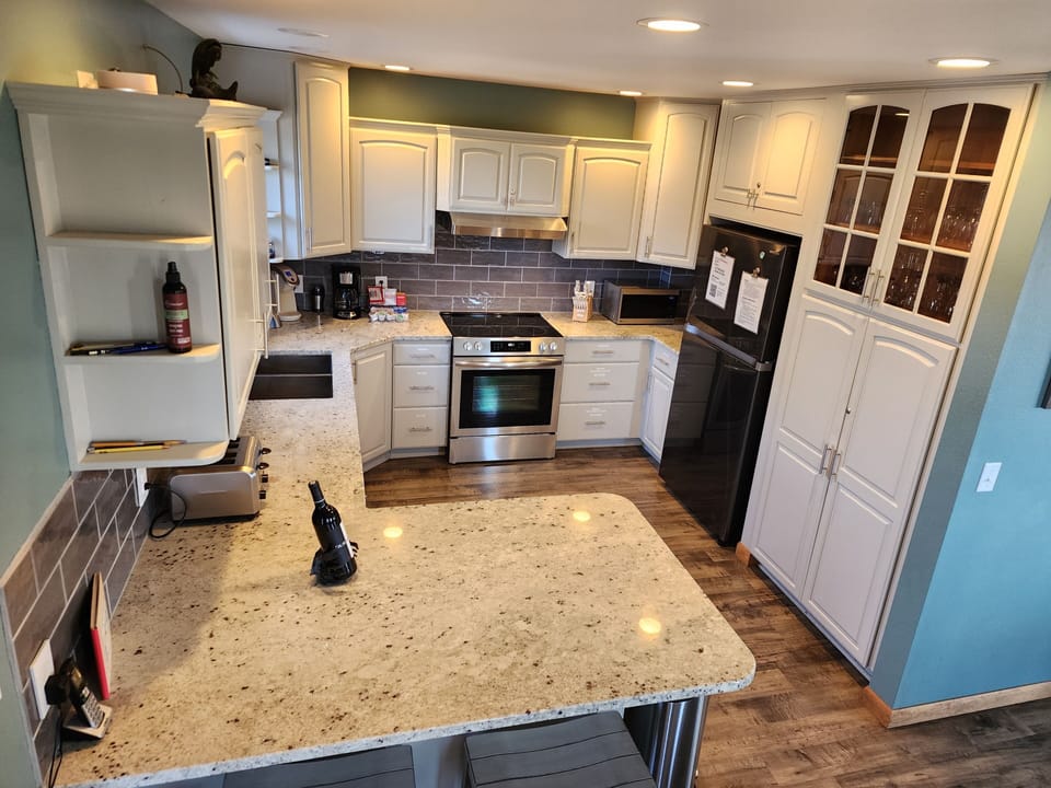 Kitchen with granite countertops and new appliances (August 2023)