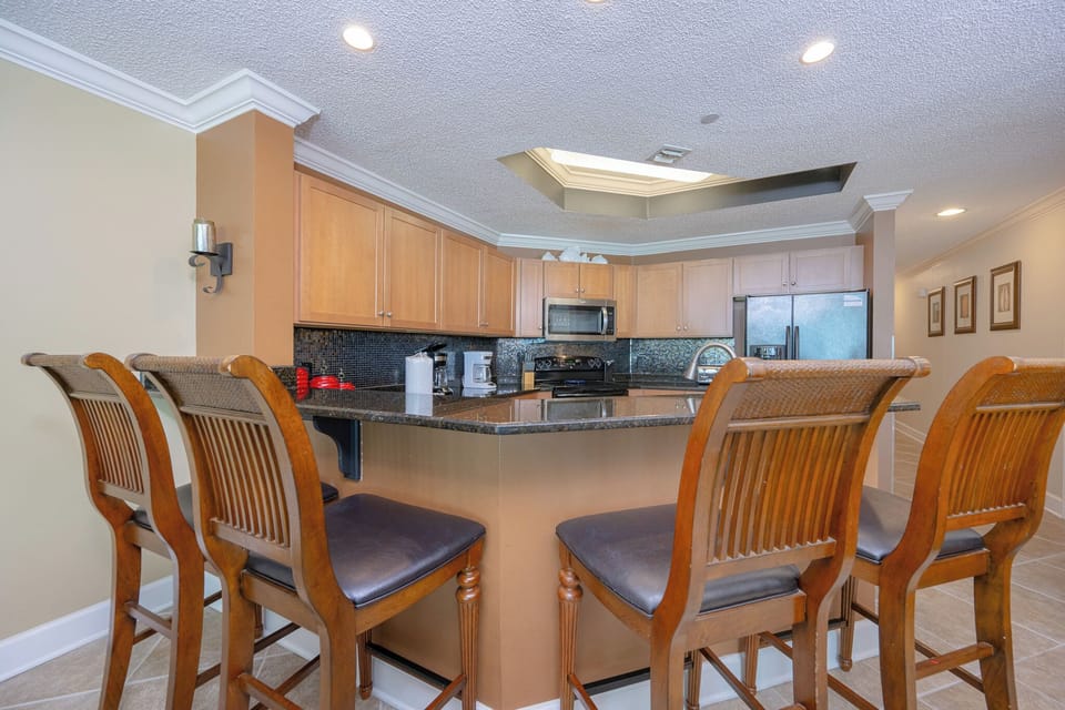 Pull up a chair at the breakfast bar where laughter and the smell of fresh coffee fill the air in the kitchen