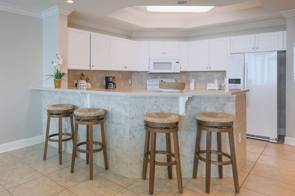 Gather around the stylish bar stools, sharing laughter and stories as you enjoy quality time in the inviting kitchen space