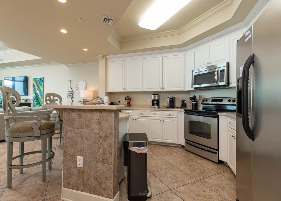 Prepare meals in this kitchen with sleek cabinetry, stainless appliances, and spacious countertops