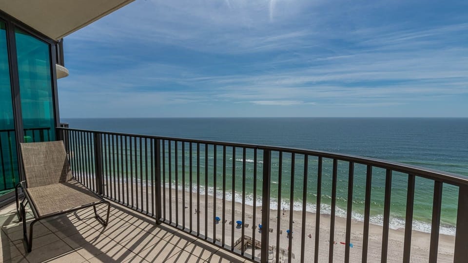 Relax on your balcony, soaking in the expansive views of the beach and gentle waves below