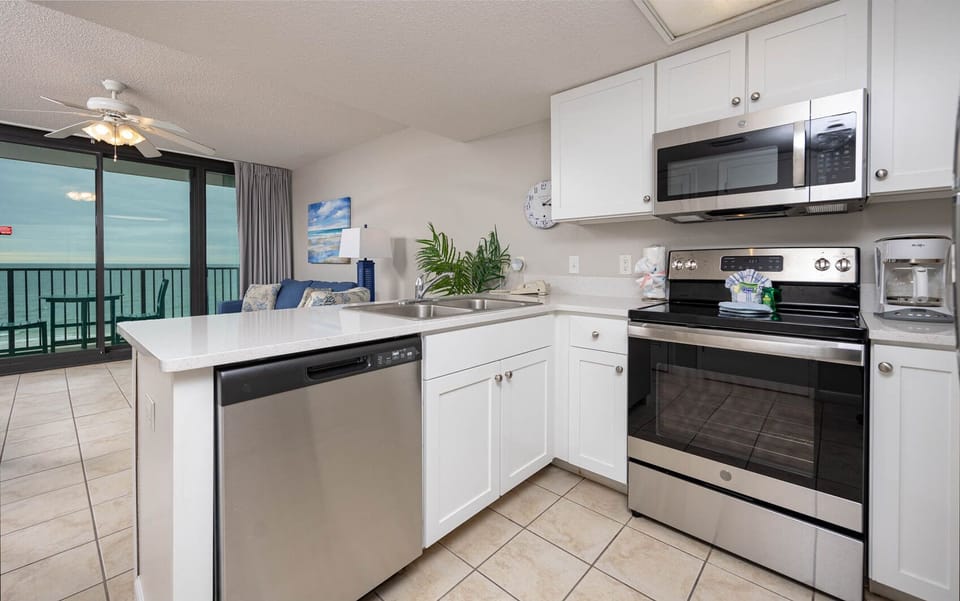 Discover a hotel kitchen that brings home to the beach with you featuring stainless appliances and spacious counters