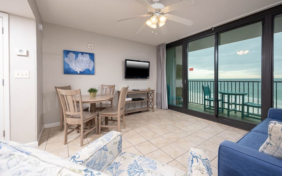 Relax in this inviting living space with a dining area, comfortable seating, and views of the beach beyond