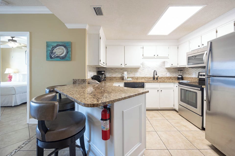 Prepare meals at the granite counter, enjoying the bright kitchen with stainless appliances and a welcoming vibe