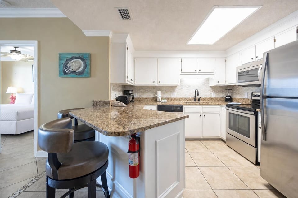 Prepare meals at the granite counter, enjoying the bright kitchen with stainless appliances and a welcoming vibe