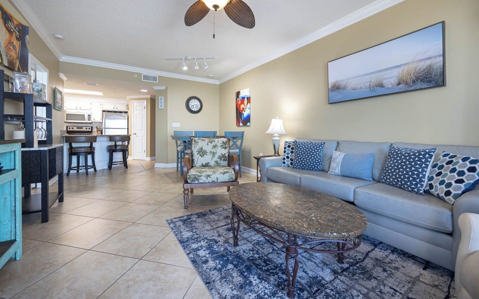 Relax in the inviting living area with comfortable seating, a stylish coffee table, and a view of the dining space