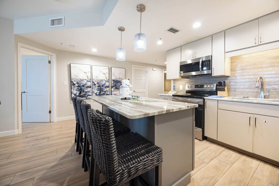 Gather around the sleek island with stylish seating, perfect for casual meals and enjoying time with loved ones