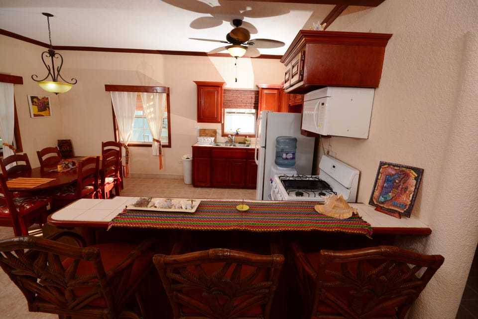 Another view of kitchen with additional chair back bar stools seating for 3 