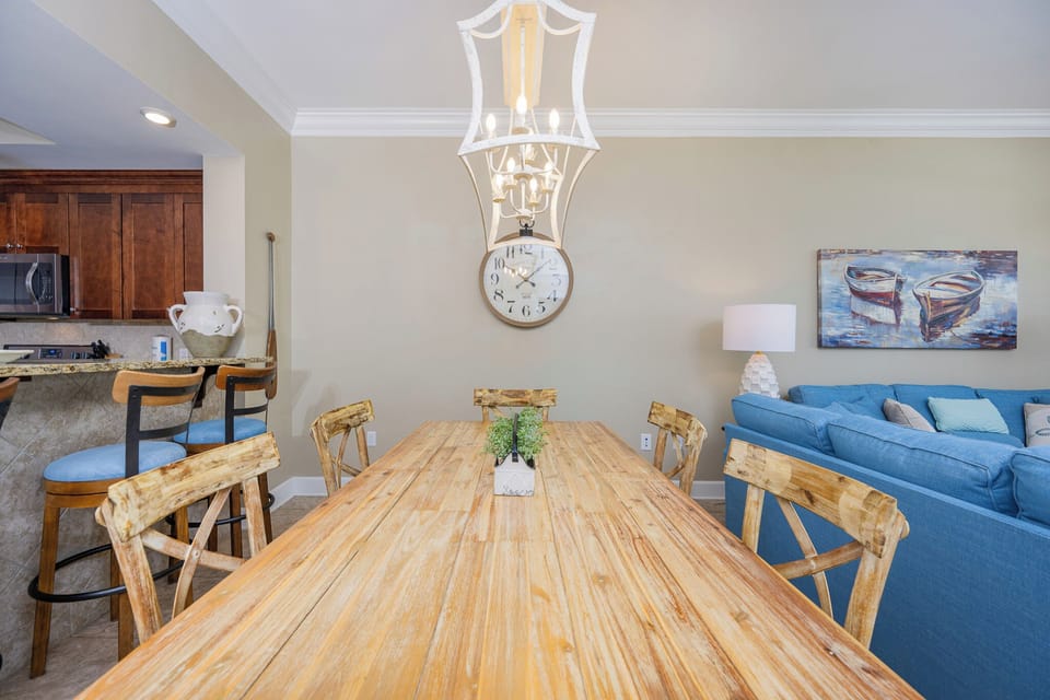 Dine at the rustic wooden table, surrounded by comfortable seating and charming decor