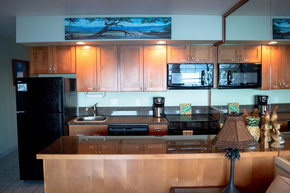Kitchen includes fridge, range, oven and microwave appliances