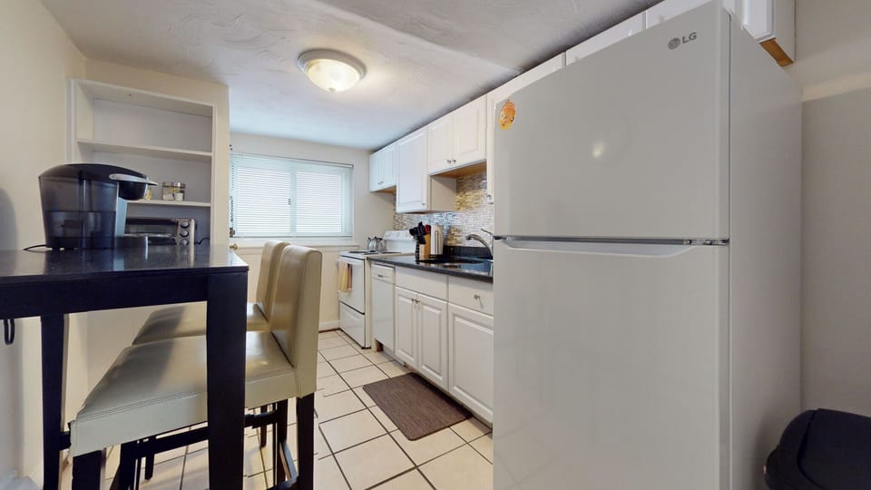 Compact kitchen with a breakfast bar and modern appliances.