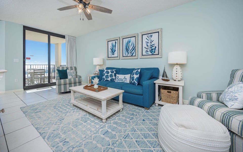 Relax in this inviting living room with a queen sofa-sleeper and stunning beachfront view from the balcony